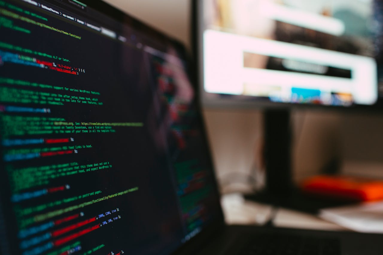 A detailed view of programming code displayed on a laptop screen, depicting a tech workspace.